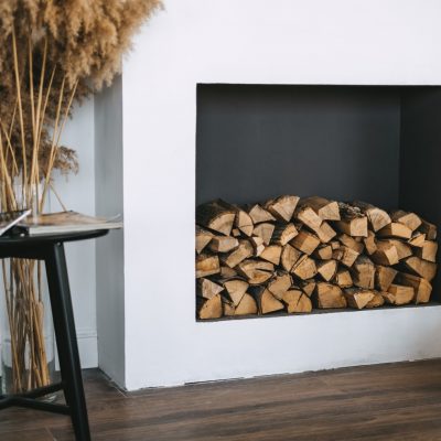 Firewood for a fireplace on a shelf in the living room interior.