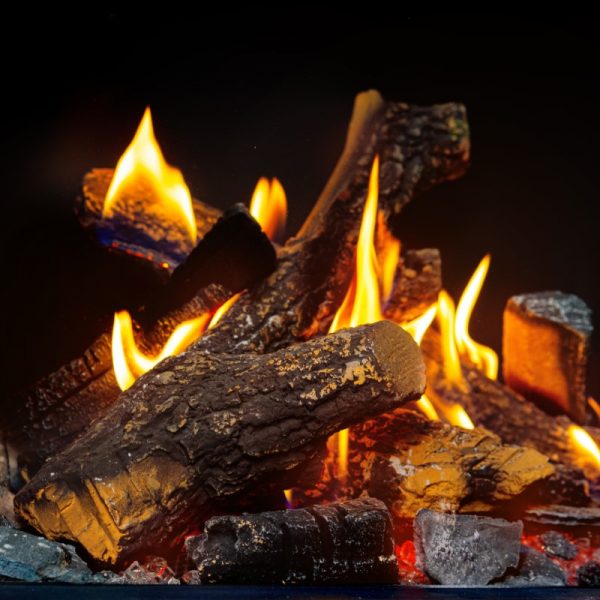 Wood logs burning in fireplace close up indoors